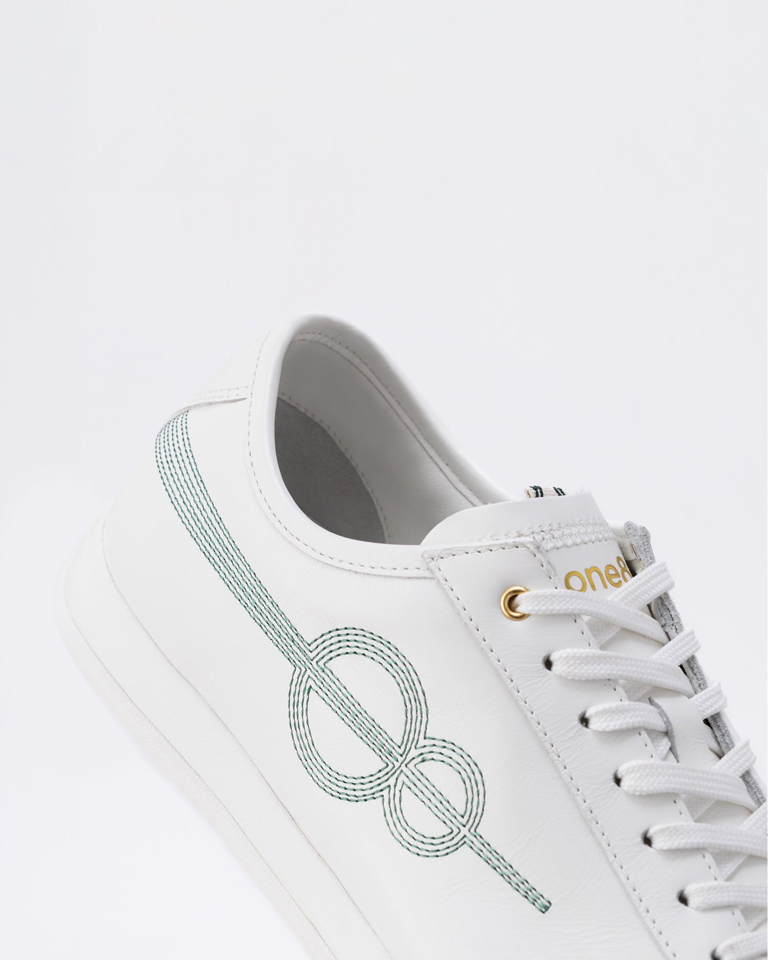 Ball White · forest-green seam, gold eyelet